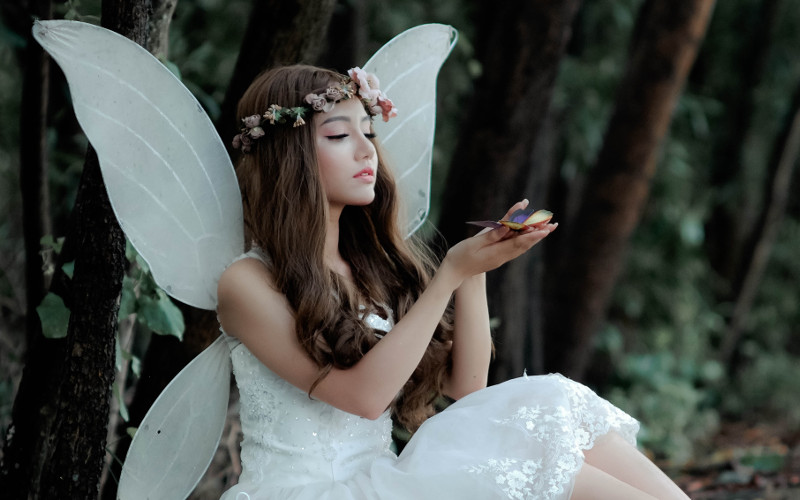 A sweet fairy watching a butterfly