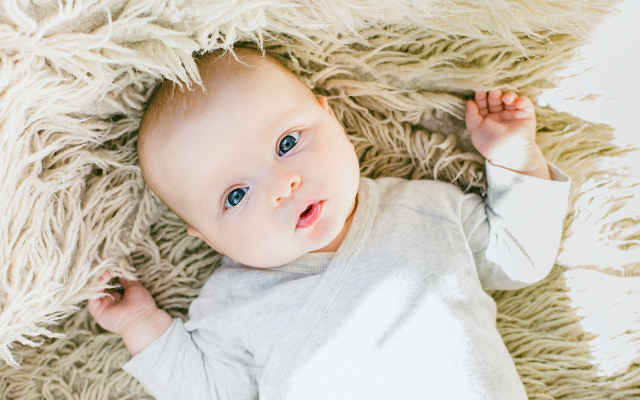 A Newborn Baby Looking Up At The World